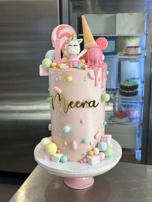 7" x 6 layer blush base + fondant figurine + lollies + sprinkles + acrylic gold front topper