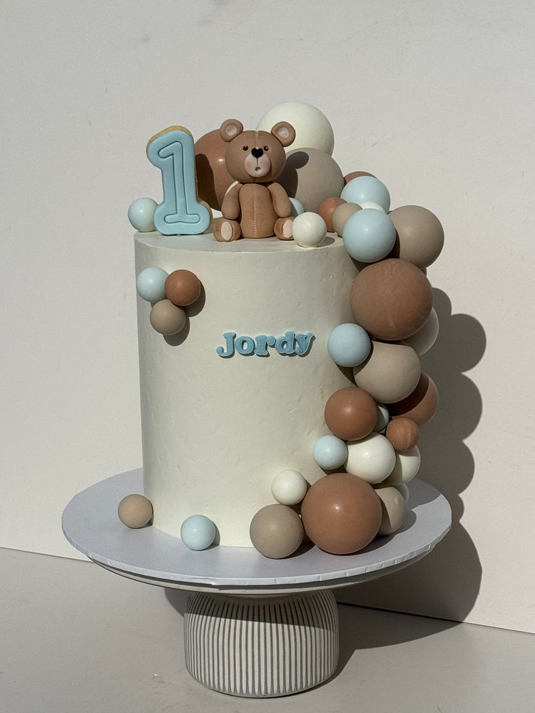 7" x 4 layer + fondant bear + inedible 'balloons' + fondant name on cake + cookie number topper