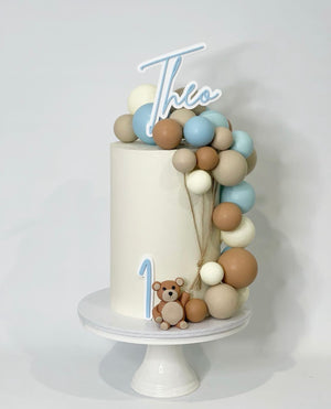 Fondant teddy figurine with choc spheres, a double layer topper & front topper 